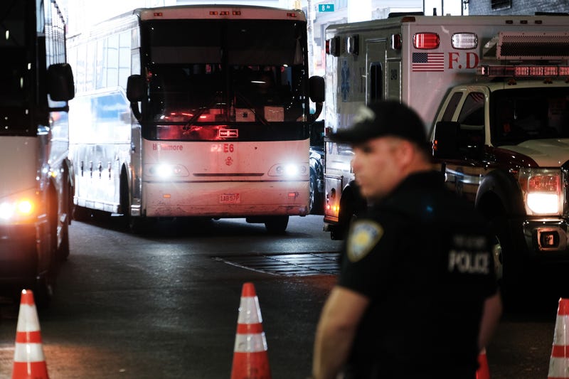 A bus carrying migrants who crossed the border from Mexico into Texas arrives at Port Authority bus station in Manhattan on Aug. 25, 2022