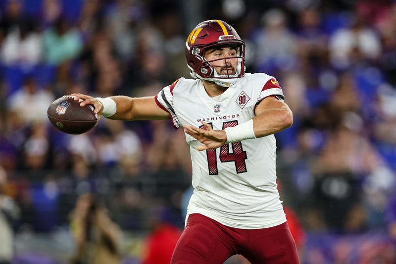 Washington Commanders quarterback Sam Howell prepares to throw a pass during a 2022 NFL preseason game against the Baltimore Ravens.