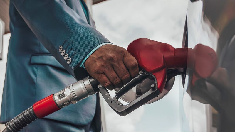 A person pumping gas.