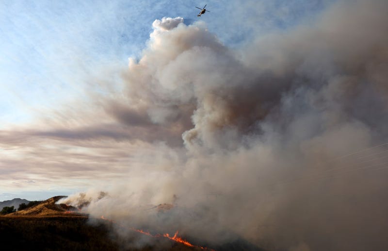 A firefighting helicopter passes above as the Route Fire burns on August 31, 2022, near Castaic, California.