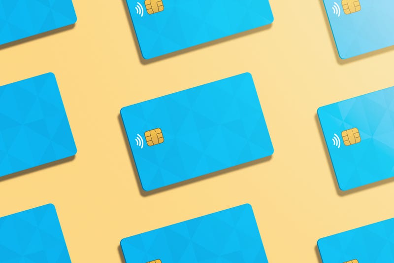 Pattern of realistic credit cards in light orange background.