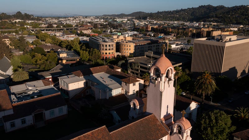 Sunset light shines on the historic Spanish Colonial mission and downtown skyline of San Rafael, California