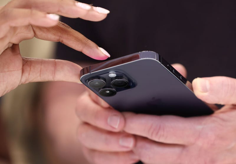 Attendees examine a brand new iPhone 14 Pro during an Apple special event on September 07, 2022 in Cupertino, California.