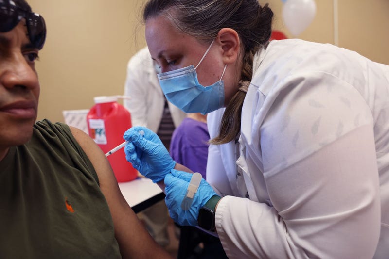 Gustavo Perez gets a COVID-19 booster shot from pharmacist Patricia Pernal during an event hosted by the Chicago Department of Public Health at the Southwest Senior Center on September 09, 2022 in Chicago, Illinois.