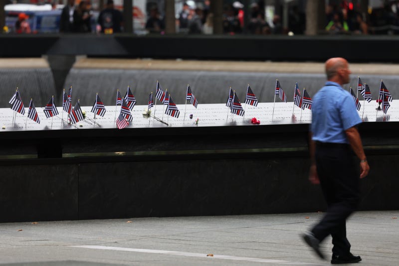  American flags are seen on the names of victims of the 9/11 terror attack during the annual 9/11 Commemoration Ceremony at the National 9/11 Memorial and Museum on September 11, 2022 in New York City.