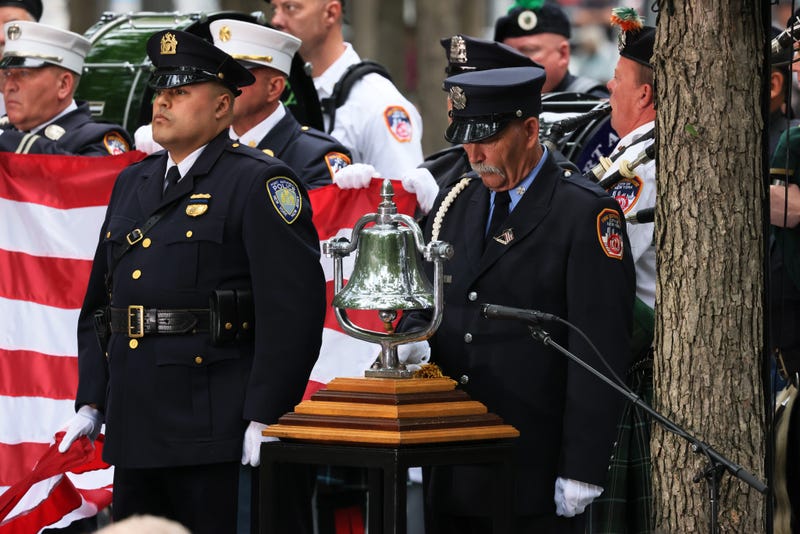 A firefighter rings the bell at 8:46 AM during the first moment of silence at the annual 9/11 Commemoration Ceremony at the National 9/11 Memorial and Museum on September 11, 2022 in New York City.