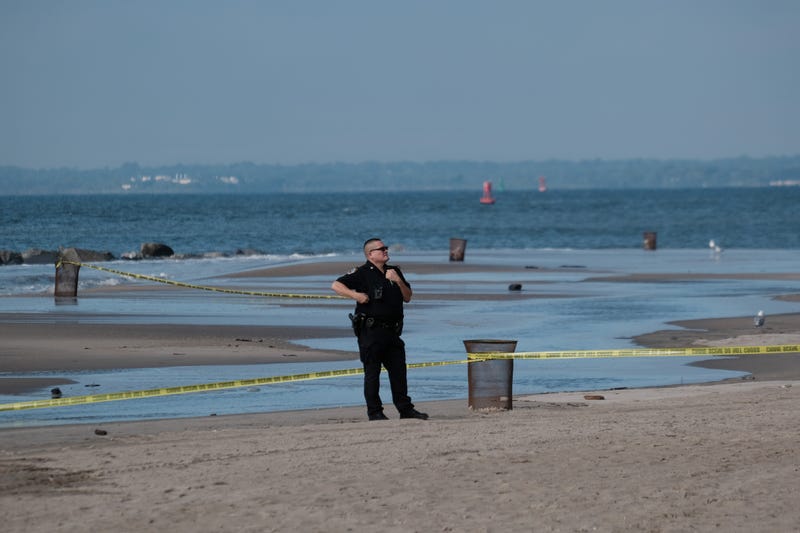 Police work along a stretch of beach at Coney Island which is now a crime scene after a mother is suspected of drowning her children in the ocean on September 12, 2022 in Brooklyn