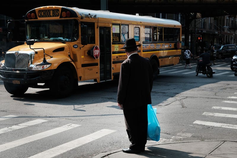 A yeshiva school bus drives through Borough Park on September 12, 2022 in the Brooklyn borough of New York City.