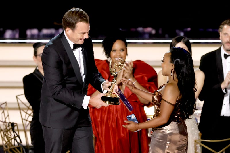 Quinta Brunson (R) accepts Outstanding Writing for a Comedy Series for "Abbott Elementary" from Will Arnett (L) during the 74th Primetime Emmys at Microsoft Theater on September 12, 2022 in Los Angeles, California.