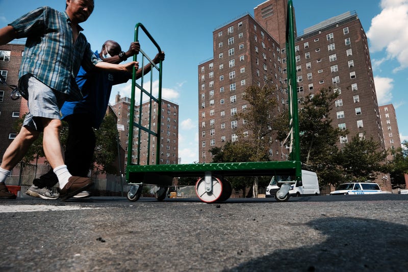 People walk through the Jacob Riis Houses as residents and activists gather for a protest against the living conditions at the public housing complex in the East Village on Sept. 14, 2022
