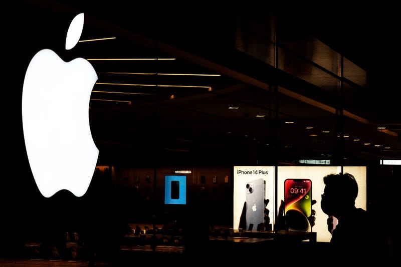 Customers line up at an Apple Store to pickup their orders of the new iPhone 14 on September 16,2022 in Wuhan. Hubei, China.