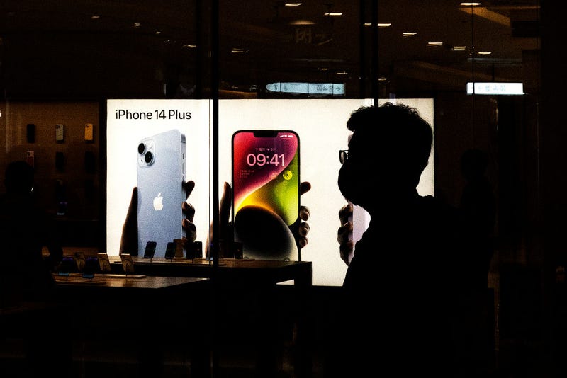 Customers line up at an Apple Store to pick up their orders of the new iPhone 14 on September 16, 2022 in Wuhan. Hubei, China. 