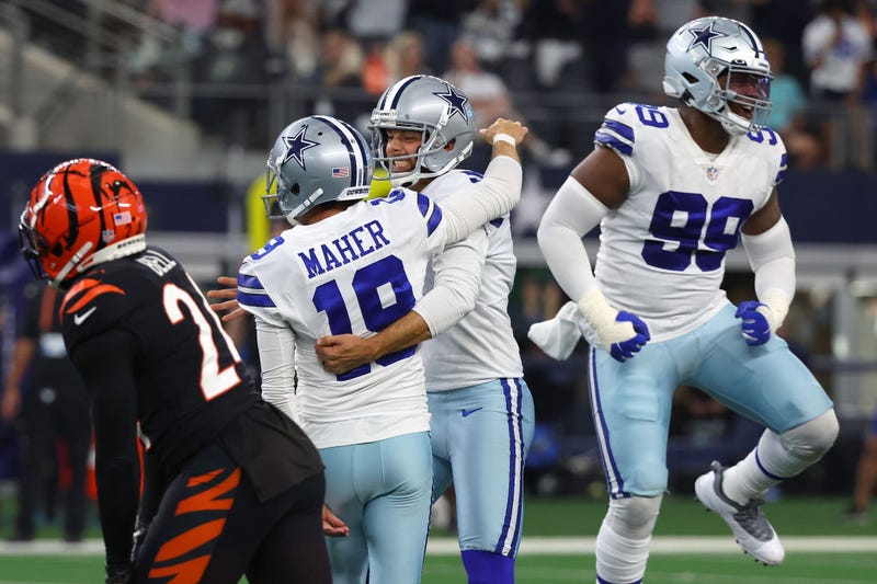 Brett Maher #19 of the Dallas Cowboys celebrates with Bryan Anger #5 (C) after making a game-winning field goal against the Cincinnati Bengals during the fourth quarter at AT&T Stadium on September 18, 2022 in Arlington, Texas.