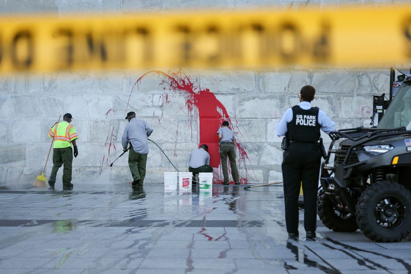 A U.S. Park Service employees remove graffiti on the Washington Monument on September 21, 2022 in Washington, DC.