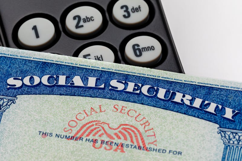 Social Security Card on top of a landline phone.