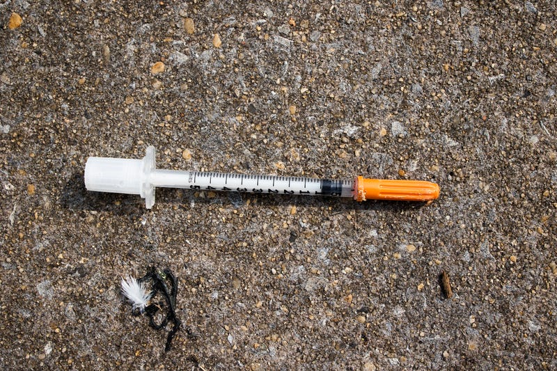 used needle on ground