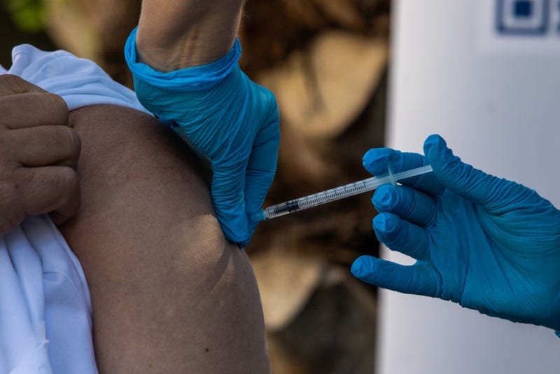 Joan Esteve Marquet, physiotherapist, and health personnel of the Feixa Llarga nursing home receive the fourth dose against Covid-19 and flu on September 26, 2022 in Barcelona, Spain.