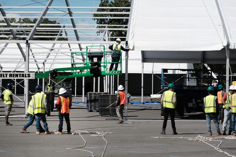 Large tents are constructed in a parking lot at Orchard Beach in the Bronx on Sept. 28, 2022