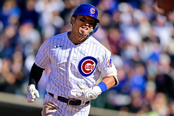 Seiya Suzuki models the home uniforms of the Cubs.