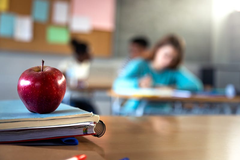 An apple on a teacher's desk. 
