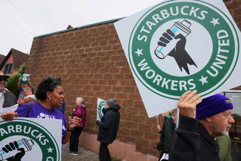 Starbucks workers hold a rally on October 05, 2022 in New York City. Starbucks Workers United were joined in solidarity by various unions as they held a rally outside of a Staten Island store, slated to close for renovations later this month. They are calling for the right to negotiate employment terms and want an end to the union busting campaign that is being used against workers throughout the country.