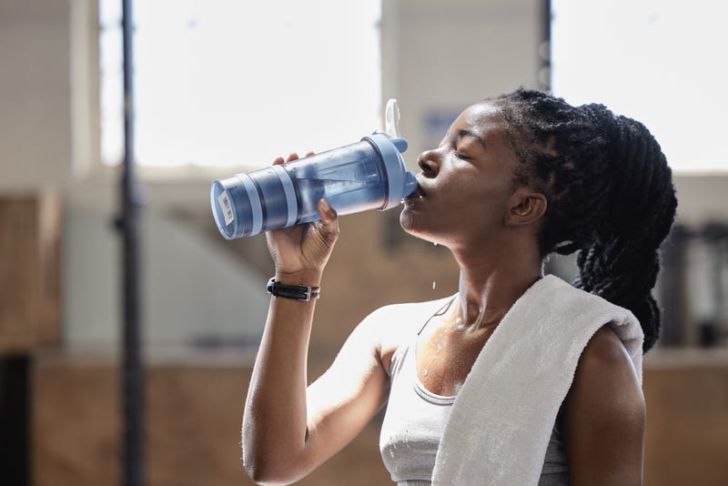 A woman drinking water.