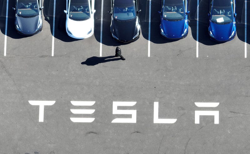 In an aerial view, brand new Tesla cars sit in a parking lot at the Tesla factory on October 19, 2022 in Fremont, California.