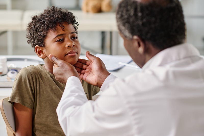 Child being checked by a doctor
