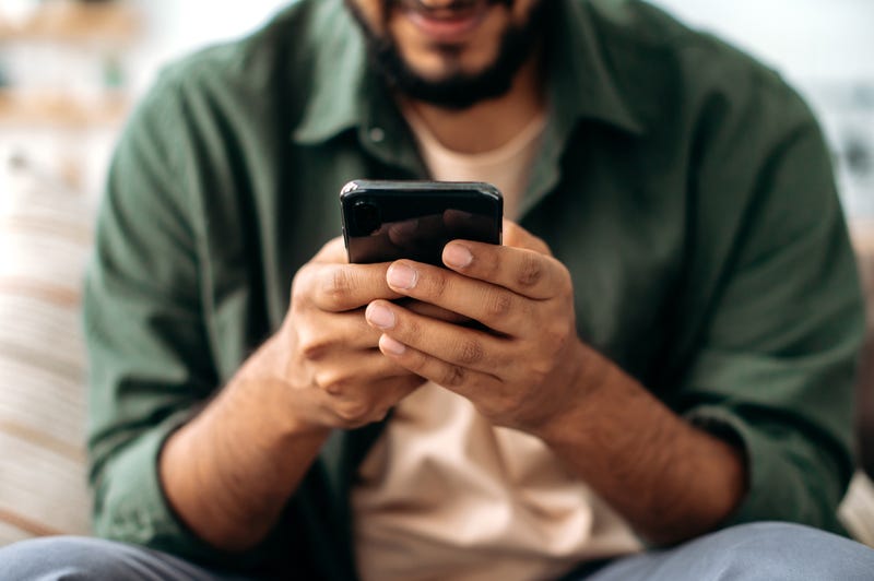 FILE: Man using a smart phone