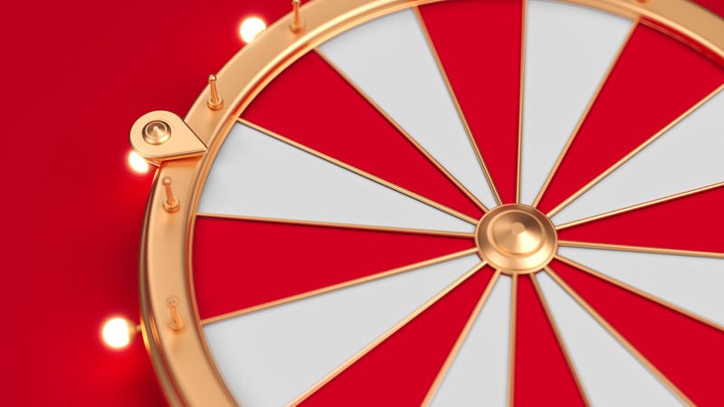 Carnival wheel on a red backdrop, close-up image. Stock photo.