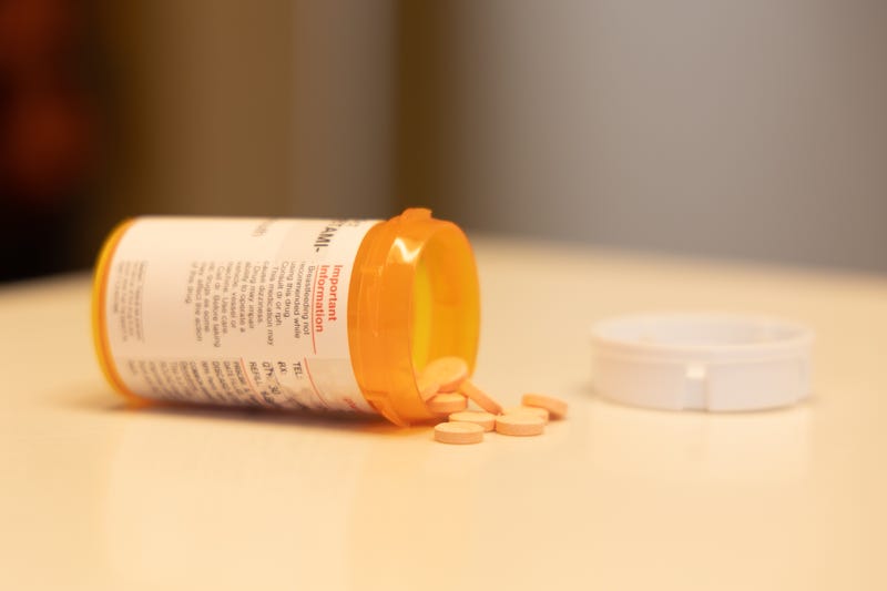 prescription bottle with pills on table