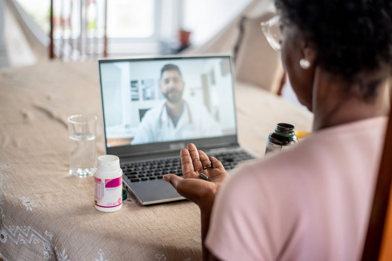 Woman in online consultation with doctor.