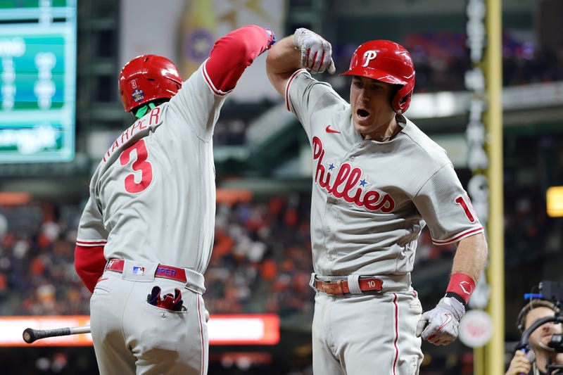 Bryce Harper and J.T. Realmuto of the Philadelphia Phillies celebrate after Realmuto hit a home run in the 10th inning against the Houston Astros in Game One of the 2022 World Series at Minute Maid Park on October 28, 2022 in Houston, Texas.