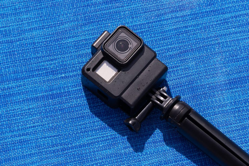 Action-style camera on a blue background. 