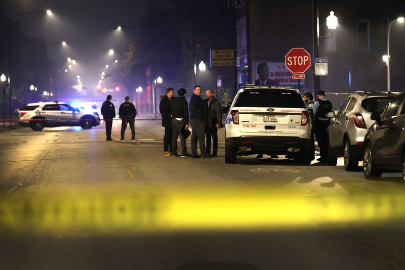 Police investigate the scene where as many as 14 people were reported to have been shot on October 31, 2022 in Chicago, Illinois. Three juveniles were among those reported to have been wounded in the drive-by shooting.