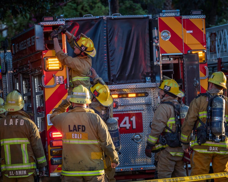 Los Angeles, CA, USA November 3, 2022: Los Angeles Fire Department firefighters put out a house fire on Martel avenue in Los Angeles, CA.
