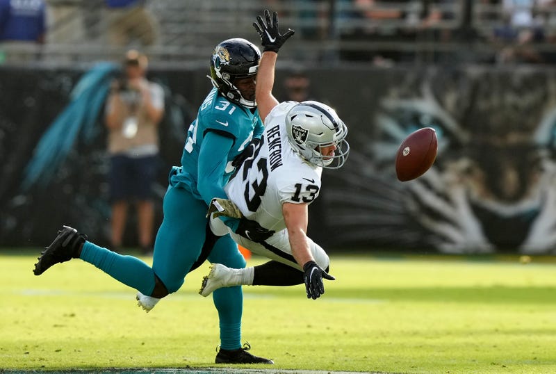 Hunter Renfrow #13 of the Las Vegas Raiders drops a catch whilst Darious Williams #31 of the Jacksonville Jaguars defends during the fourth quarter of the game at TIAA Bank Field