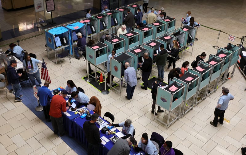 Clark County Election Department poll workers check people in at a table as people vote at the Meadows Mall on November 08, 2022 in Las Vegas.