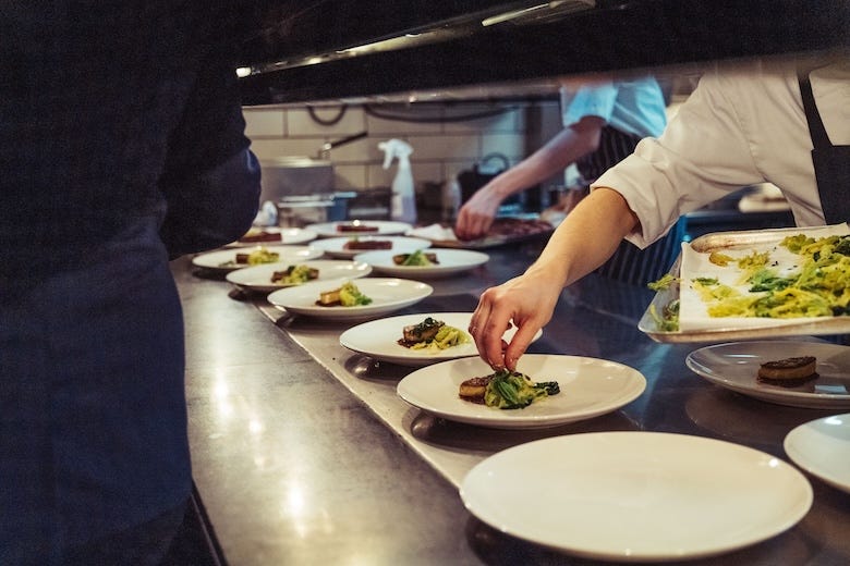 Closeup shot of the chefs preparing a fine dinner at the kitchen in a restaurant