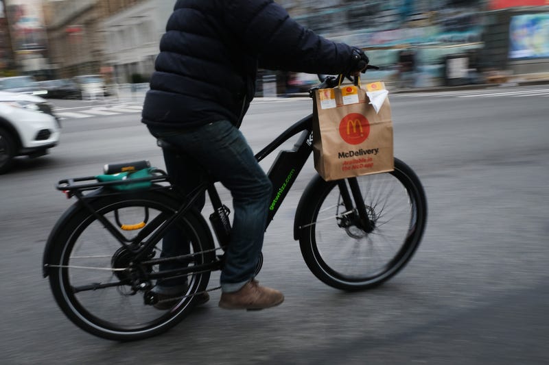 A delivery person rides an electric bicycle through the streets of Manhattan on November 15, 2022 in New York City.