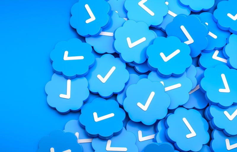 Stock art concept -- a pile of blue check marks such as those seen on Twitter.