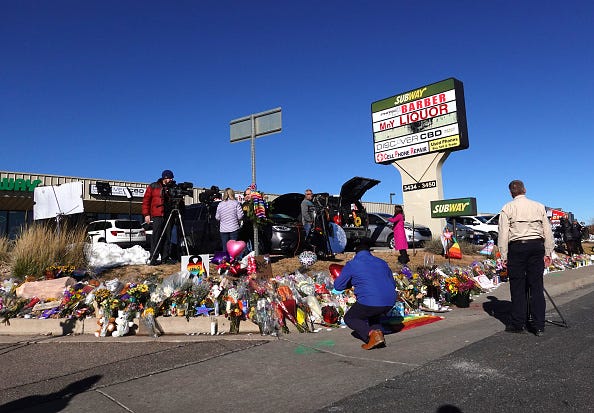 COLORADO SPRINGS, COLORADO - NOVEMBER 21: People visit a makeshift memorial near the Club Q nightclub on November 21, 2022 in Colorado Springs, Colorado
