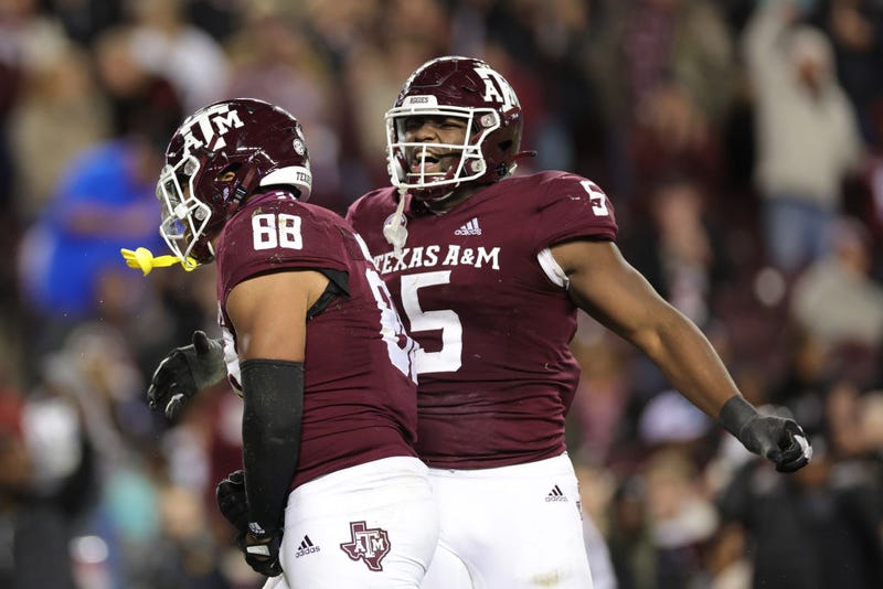 COLLEGE STATION, TEXAS - NOVEMBER 26: Shemar Turner #5 of the Texas A&M Aggies celebrates a sack with Walter Nolen #88 against the LSU Tigers during the second half at Kyle Field on November 26, 2022 in College Station, Texas.