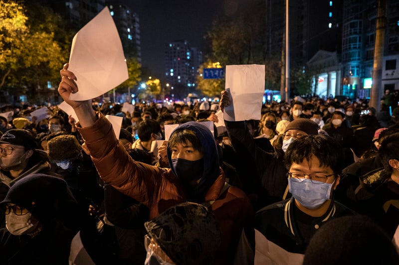 Protesters hold up pieces of paper against censorship and China's strict "zero-COVID" measures on Nov. 27, 2022, in Beijing, China. 