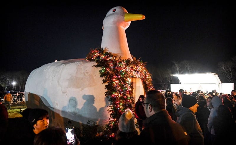 Flanders, N.Y.: People gather around the Big Duck in Flanders, New York, which was lit for the holidays during the 31st Annual Big Duck Lighting ceremony, on December 4, 2019. 
