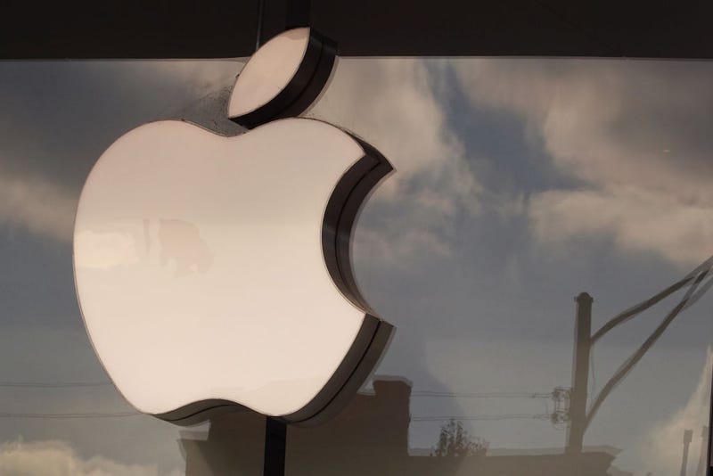 The Apple company logo hangs above an Apple retail store on November 28, 2022 in Chicago, Illinois. 