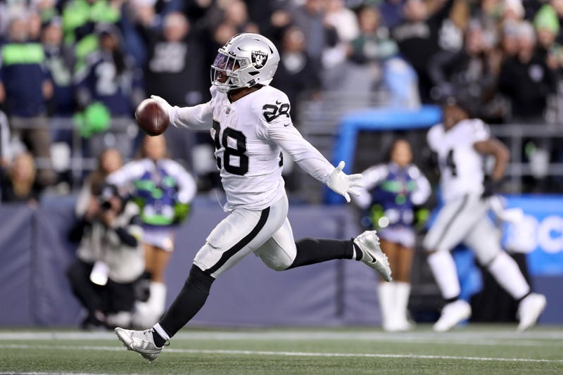 Josh Jacobs #28 of the Las Vegas Raiders celebrates after scoring a touchdown in overtime to beat the Seattle Seahawks 40-34 at Lumen Field on November 27, 2022 in Seattle.