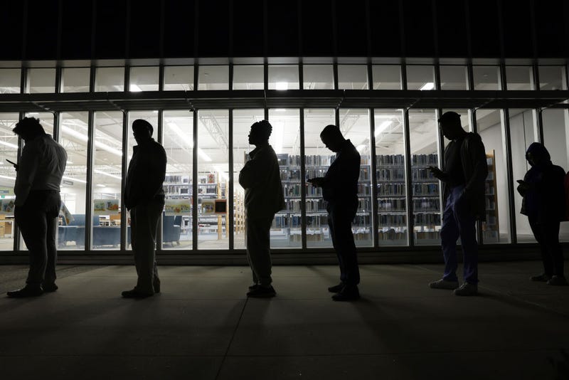 Residents wait in line to vote early outside a polling station on November 29, 2022 in Atlanta, Georgia. Early voting has started in select Georgia counties for a special runoff election days after the Georgia Supreme Court rejected an emergency request from Republicans to block counties from offering early voting. (Photo by Alex Wong/Getty Images)
