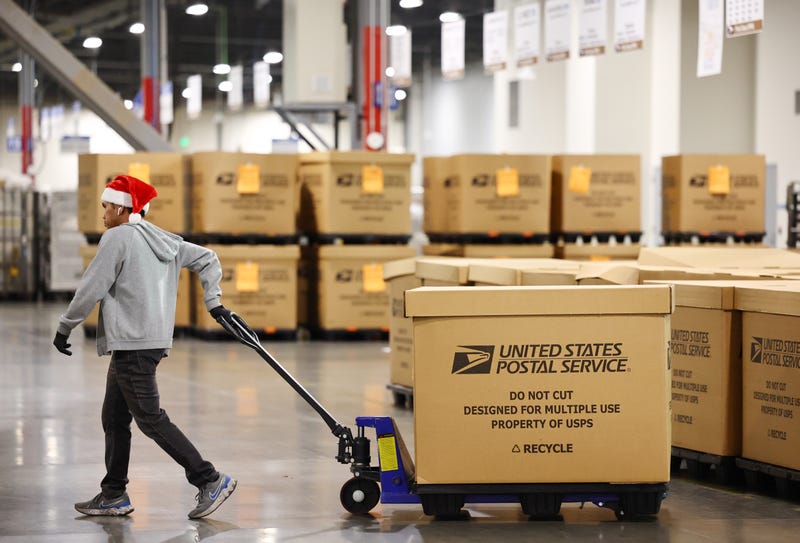 A U.S. Postal Service employee works ahead of the holiday mail rush inside the Los Angeles Processing and Distribution Center on Nov. 30, 2022 in Los Angeles, California.
