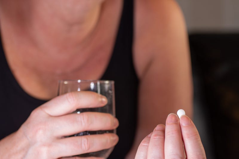 Woman taking pill